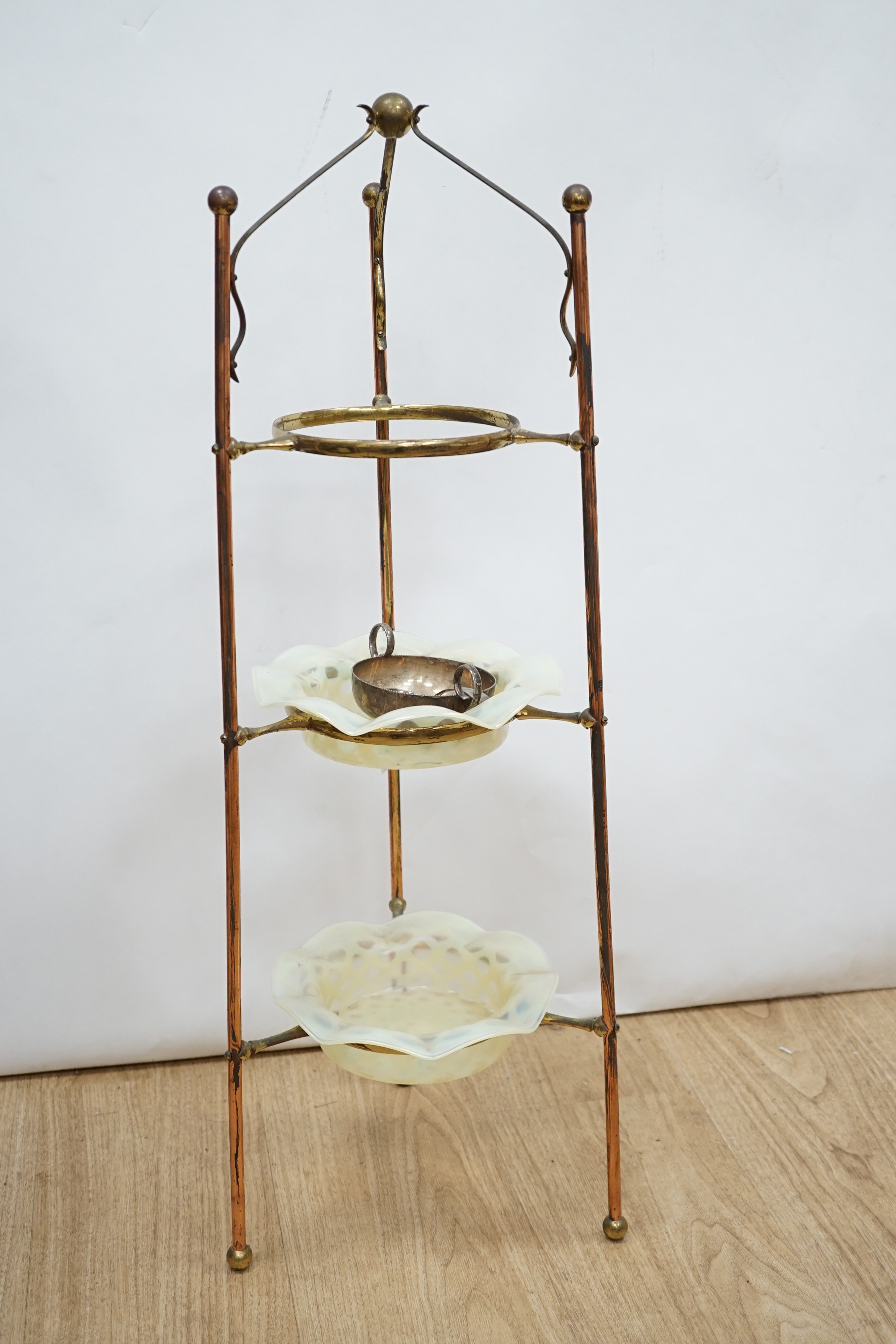 A W.A.S Benson brass and copper three tier stand, with two Vaseline glass dishes (upper dish lacking) 60 cms high.